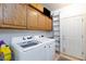 Laundry room featuring side-by-side washer and dryer and ample cabinet space at 9109 Lazy Hill Cir, Las Vegas, NV 89117