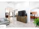 Open-concept living room offering sleek floors, modern decor, and seamless transition to the kitchen and dining area at 9109 Lazy Hill Cir, Las Vegas, NV 89117