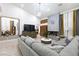 Spacious living room with modern lighting, fireplace, large grey sofa and neutral walls at 9109 Lazy Hill Cir, Las Vegas, NV 89117