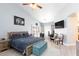 Spacious main bedroom features a ceiling fan, lots of natural light, and cozy seating area at 9109 Lazy Hill Cir, Las Vegas, NV 89117