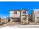 Two-story house with a brown garage door and landscaped front yard at 9888 Abel Cliff St, Las Vegas, NV 89143