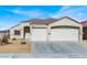 Two-car garage and front yard view of a single-story house at 1006 Christopher View Ave, North Las Vegas, NV 89032