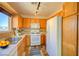 Well-equipped kitchen with wood cabinets and updated flooring at 10484 Beautiful Fruit St, Las Vegas, NV 89183