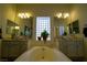 Bathroom boasts double sinks, a large soaking tub, and a glass block window at 10500 Eagle Nest St, Las Vegas, NV 89141