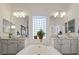 Bathroom with double sinks, a large soaking tub, and a block window at 10500 Eagle Nest St, Las Vegas, NV 89141