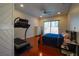 Bright bedroom featuring hardwood floors and sliding door access to backyard at 10500 Eagle Nest St, Las Vegas, NV 89141