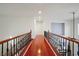 Bright hallway with hardwood floors and iron railings at 10500 Eagle Nest St, Las Vegas, NV 89141