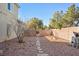 Landscaped side yard with gravel pathway and trees at 10500 Eagle Nest St, Las Vegas, NV 89141