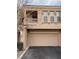 Tan two-story townhome with attached garage and balcony at 10550 W Alexander Rd # 2082, Las Vegas, NV 89129