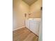 Bright laundry room with washer, dryer, and shelving at 10550 W Alexander Rd # 2082, Las Vegas, NV 89129