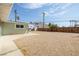 Backyard view showcasing gravel, a partial view of the house, and a wooden fence at 1105 I, Boulder City, NV 89005