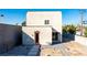 Modern stucco home with private backyard and orange door at 1303 S 8Th St, Las Vegas, NV 89104