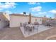 Backyard patio with seating, umbrella, and fire pit at 1320 Indian Hedge Dr, North Las Vegas, NV 89032