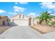 Single-story house with attached garage and desert landscaping at 1320 Indian Hedge Dr, North Las Vegas, NV 89032