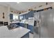 Spacious kitchen with island, stainless steel appliances, and blue cabinets at 1320 Indian Hedge Dr, North Las Vegas, NV 89032