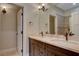 Elegant bathroom with double vanity, large mirror, and a separate shower at 1323 Red Baron Ln, Boulder City, NV 89005