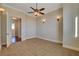 Spacious bedroom with ceiling fan and carpet at 1323 Red Baron Ln, Boulder City, NV 89005