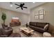 Living room with leather sofas and a large TV at 1323 Red Baron Ln, Boulder City, NV 89005