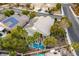 Aerial view showing a house with a pool, solar panels and palm trees at 1350 Rossini St, Henderson, NV 89052