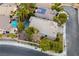 An aerial view showcasing a house with a large backyard, pool, and solar panels at 1350 Rossini St, Henderson, NV 89052