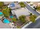 House with pool and spa, solar panels, and lush landscaping seen from above at 1350 Rossini St, Henderson, NV 89052