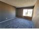 Spacious bedroom with window and gray carpet at 1480 Hialeah Dr # B, Las Vegas, NV 89119