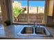 Kitchen sink with granite countertop and view of backyard at 1480 Hialeah Dr # B, Las Vegas, NV 89119