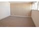 Simple bedroom with neutral carpeting and wood paneling at 1804 Piccolo Way, Las Vegas, NV 89146