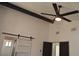 Bright bedroom featuring a ceiling fan and barn door at 1804 Piccolo Way, Las Vegas, NV 89146