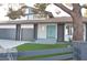 Updated home exterior, featuring a teal front door and artificial turf landscaping at 1804 Piccolo Way, Las Vegas, NV 89146