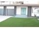 Two story home with teal front door and artificial turf at 1804 Piccolo Way, Las Vegas, NV 89146