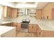 Modern kitchen with light wood cabinets, quartz countertops, and herringbone backsplash at 1804 Piccolo Way, Las Vegas, NV 89146