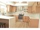 Modern kitchen with light wood cabinets, quartz countertops and herringbone backsplash at 1804 Piccolo Way, Las Vegas, NV 89146