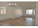 Spacious living room with large window and wood-look floors at 1804 Piccolo Way, Las Vegas, NV 89146