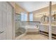 Elegant bathroom with a corner tub, separate shower, and double vanity at 1805 Grand Rodeo St, Las Vegas, NV 89117