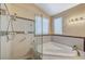 Bathroom with corner tub, shower, and updated tile at 1805 Grand Rodeo St, Las Vegas, NV 89117