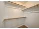 Walk-in closet with wood shelving and hanging rods at 1805 Grand Rodeo St, Las Vegas, NV 89117