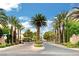 Gated entrance to Wellington Park community, featuring palm trees and stonework at 1805 Grand Rodeo St, Las Vegas, NV 89117