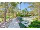 Landscaped walking path with benches and mature trees at 1805 Grand Rodeo St, Las Vegas, NV 89117