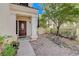 Two-story house with a brown front door and landscaping at 1805 Grand Rodeo St, Las Vegas, NV 89117