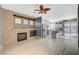 Living room with stone fireplace and kitchen access at 1805 Grand Rodeo St, Las Vegas, NV 89117