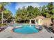 Inviting community pool with a unique shape and surrounding landscaping at 1805 Grand Rodeo St, Las Vegas, NV 89117