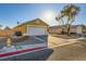 Tan house exterior with a white garage door, fire hydrant visible at 2210 Cool River Ct, North Las Vegas, NV 89032