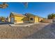 Tan house exterior with a walkway and gravel landscaping at 2210 Cool River Ct, North Las Vegas, NV 89032