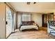 Living room with a brown leather couch and sliding glass door to patio at 2210 Cool River Ct, North Las Vegas, NV 89032