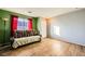 Living room showcasing wood-look floors and green/gray walls at 2210 Cool River Ct, North Las Vegas, NV 89032