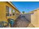 Side yard with gravel, two chairs, and bicycles at 2210 Cool River Ct, North Las Vegas, NV 89032