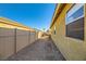 Side yard with gravel pathway and privacy fence at 2210 Cool River Ct, North Las Vegas, NV 89032