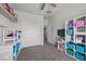 bedroom with built-in shelving, window, and sliding door to hallway at 2465 Sturrock Dr, Henderson, NV 89044