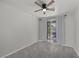 Bedroom with gray carpeting, ceiling fan, and sliding glass door to balcony at 2465 Sturrock Dr, Henderson, NV 89044